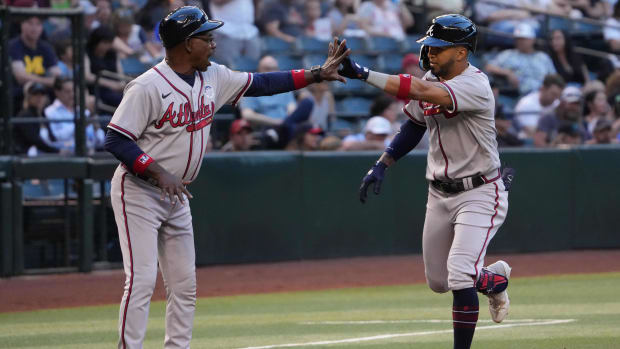 Jun 2, 2023; Phoenix, Arizona, USA; Atlanta Braves left fielder Eddie Rosario (8) slaps hands with Atlanta Braves third base coach Ron Washington (37) after hitting a solo home run against the Arizona Diamondbacks during the second inning at Chase Field.
